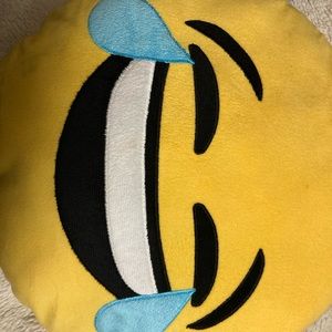 Two different emoji pillows comes together